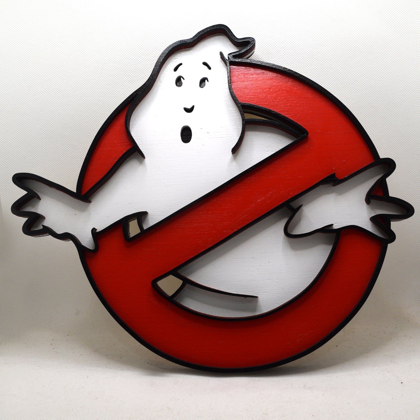 Ghostbusters logo with a white ghost on a red circle against a white background