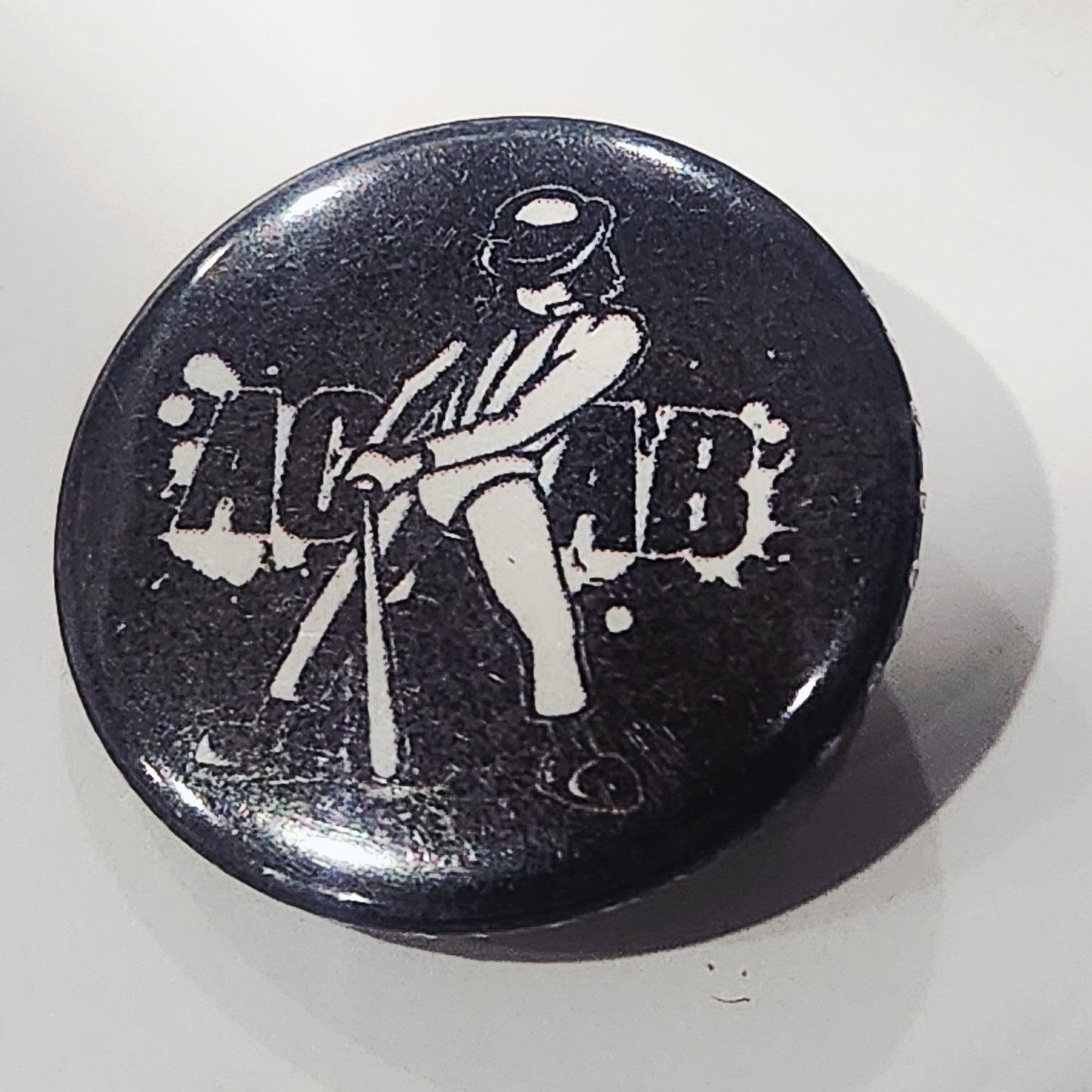 Black button with white graphic of a Alex from a Clockwork orange
