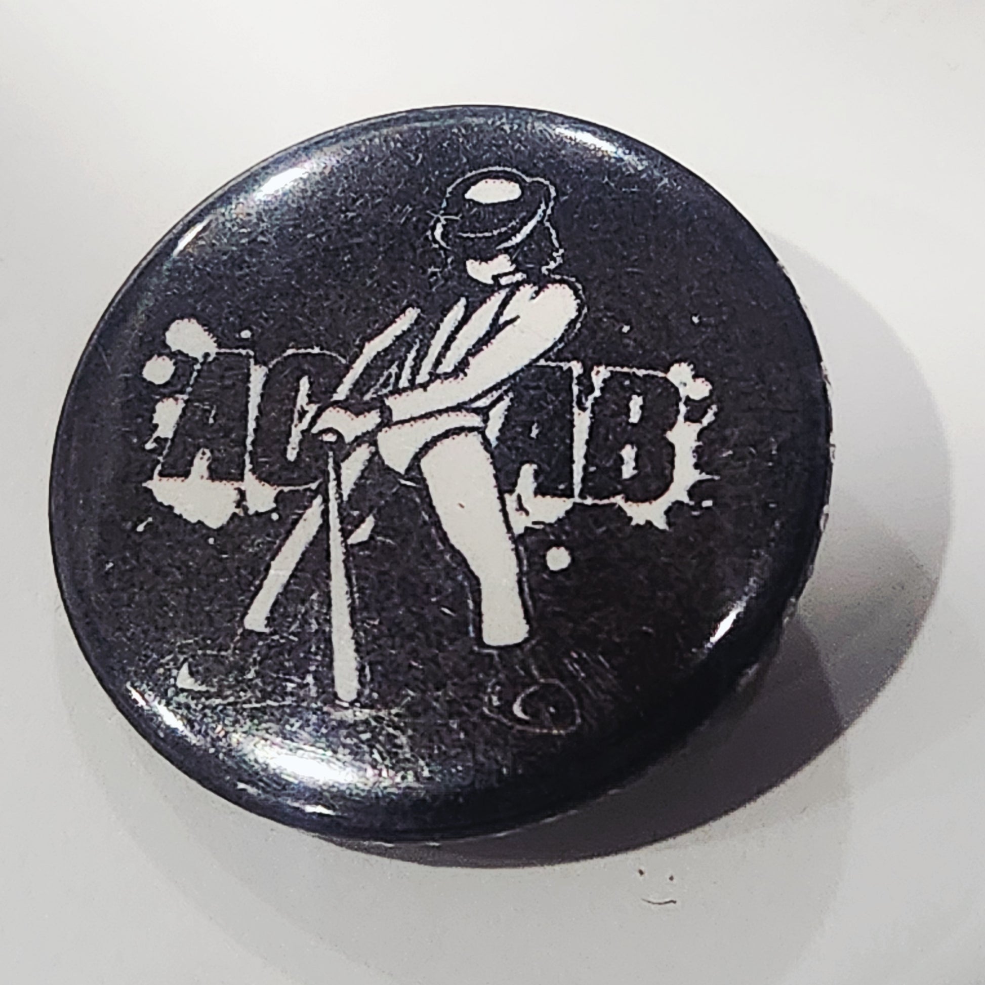 Black button with white graphic of a Alex from a Clockwork orange