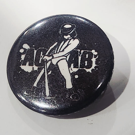Black button with white graphic of a Alex from a Clockwork orange