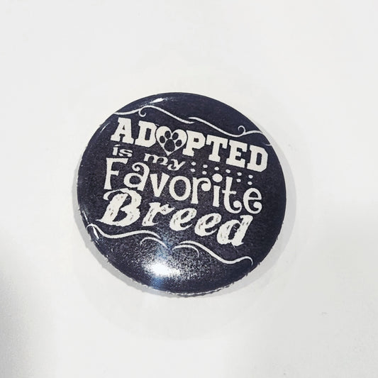 Button badge with 'Adopted is my Favorite Breed' text on a black background