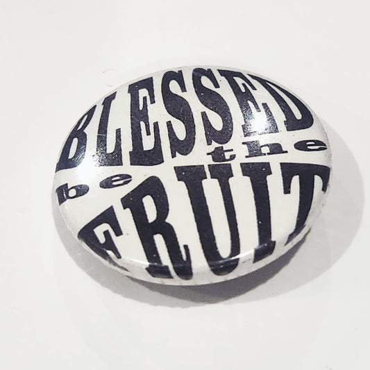 Round stone with 'Blessed be the fruit' text on a white background