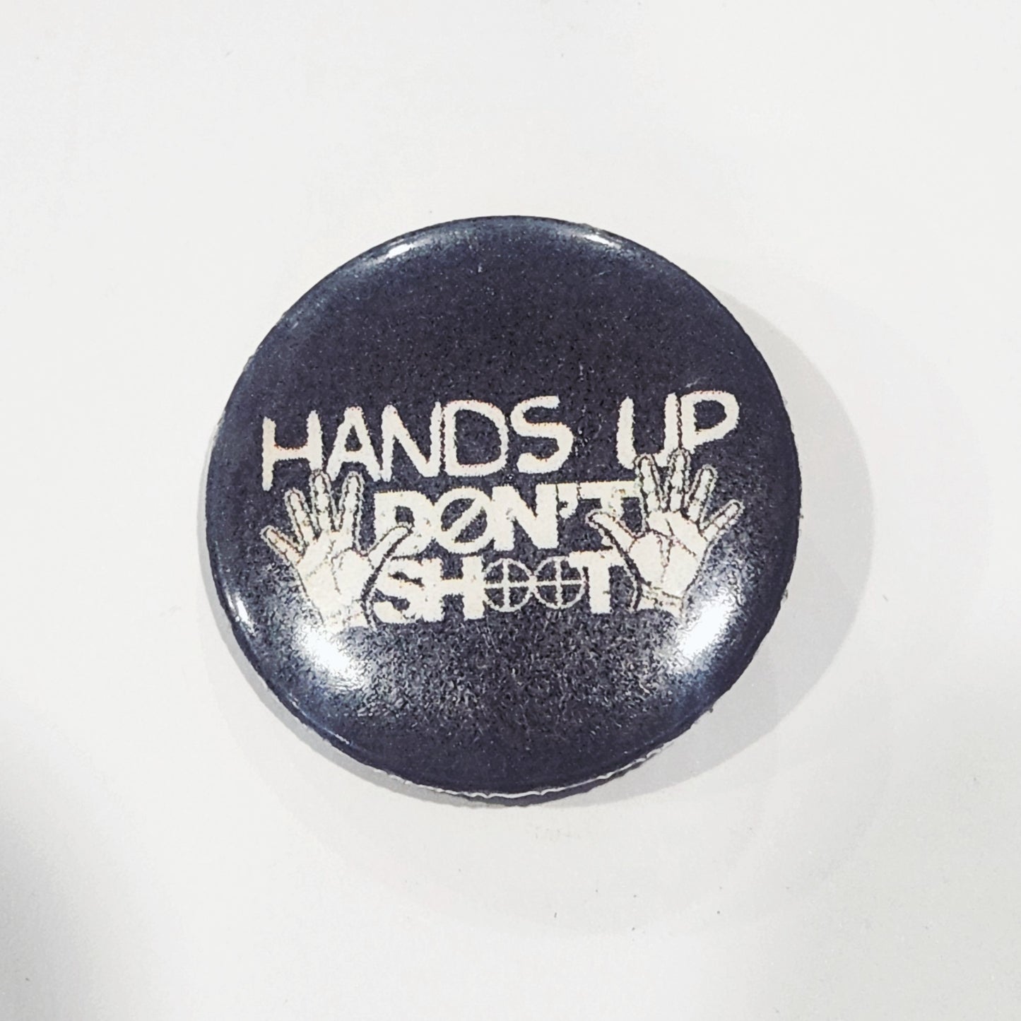 Button badge with 'Hands Up Don't Shoot' text 