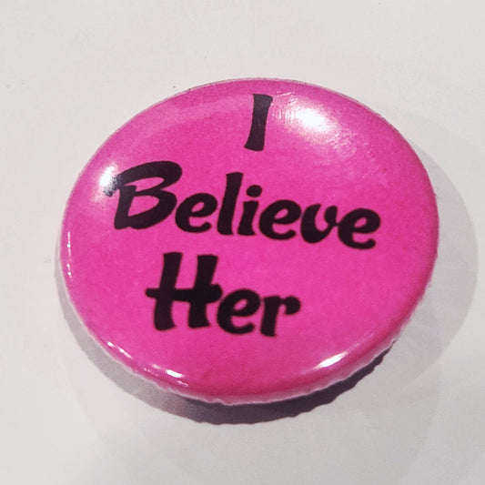 Pink button with 'I Believe Her' text on a white background