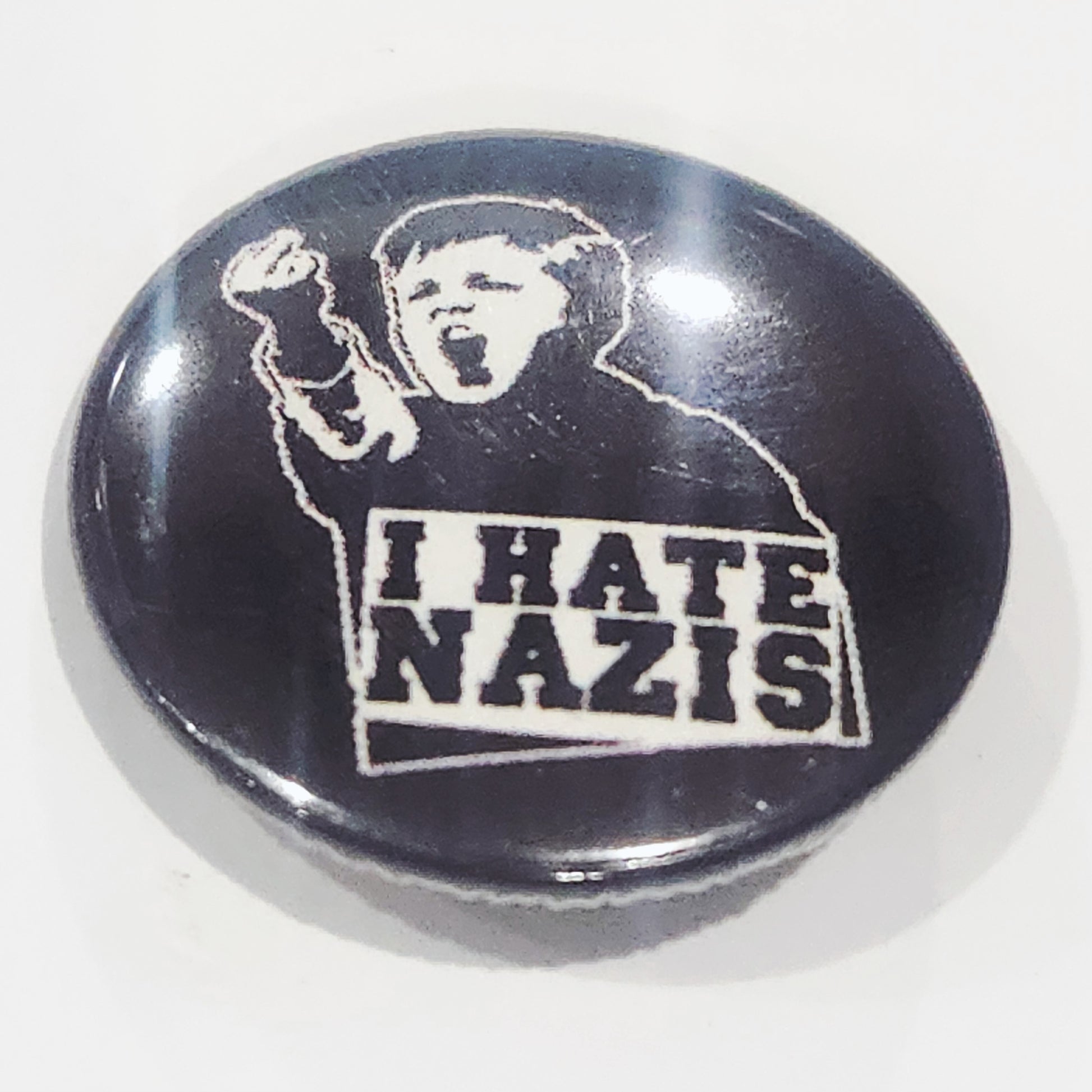 Button badge with graphic of a child and 'I HATE NAZIS' text on a black background