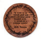Wooden coaster with engraved J.R.R. Tolkien quote on a white background