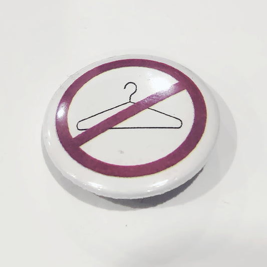 Button badge with a no-hangers symbol on a white background