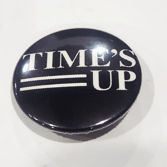 Round button badge with 'TIME'S UP' text on a white background