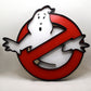 Ghostbusters logo with a white ghost on a red circle against a white background